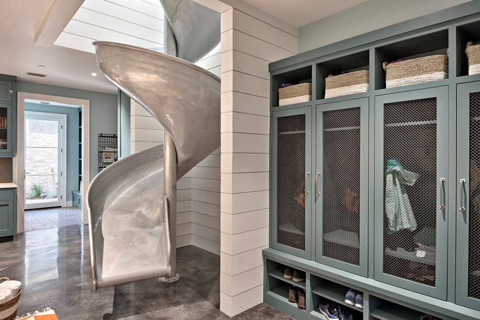This is an example of a contemporary laundry room in Austin with turquoise cabinets, concrete floors and grey floor.