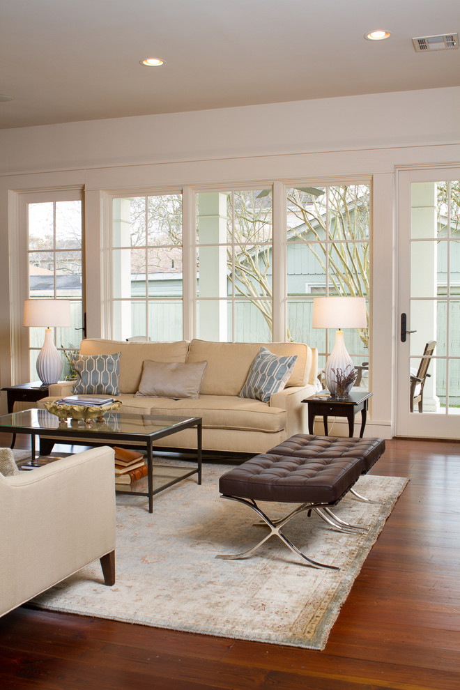 Inspiration for a traditional living room in New Orleans with white walls and medium hardwood floors.