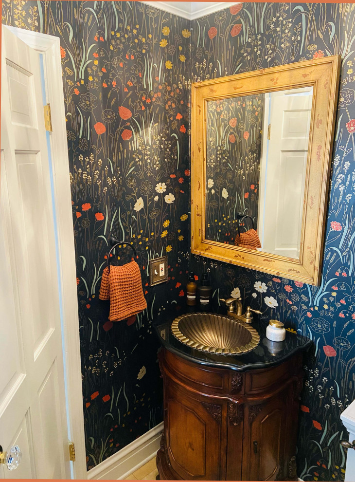 Small traditional cloakroom in Chicago with freestanding cabinets, brown cabinets, ceramic flooring, a built-in sink, granite worktops, beige floors, black worktops, a freestanding vanity unit and wallpapered walls.