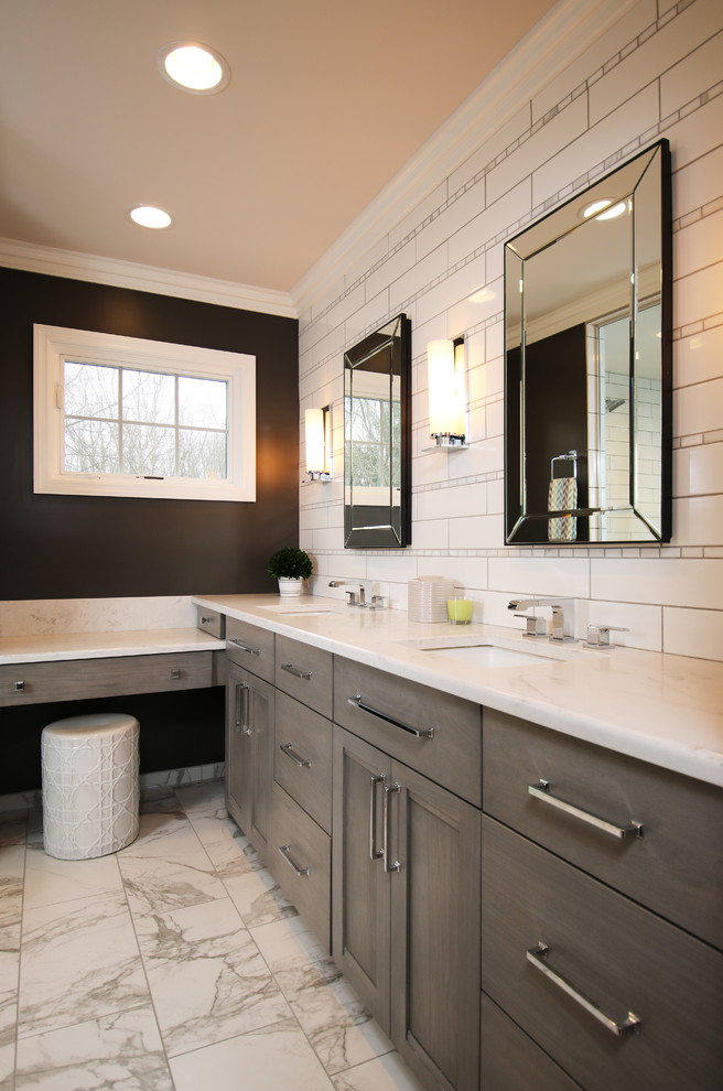 Inspiration for a mid-sized contemporary master bathroom in Columbus with flat-panel cabinets, white cabinets, an alcove tub, a curbless shower, a wall-mount toilet, white tile, porcelain tile, brown walls, porcelain floors, an undermount sink, marble benchtops, multi-coloured floor, a hinged shower door and multi-coloured benchtops.