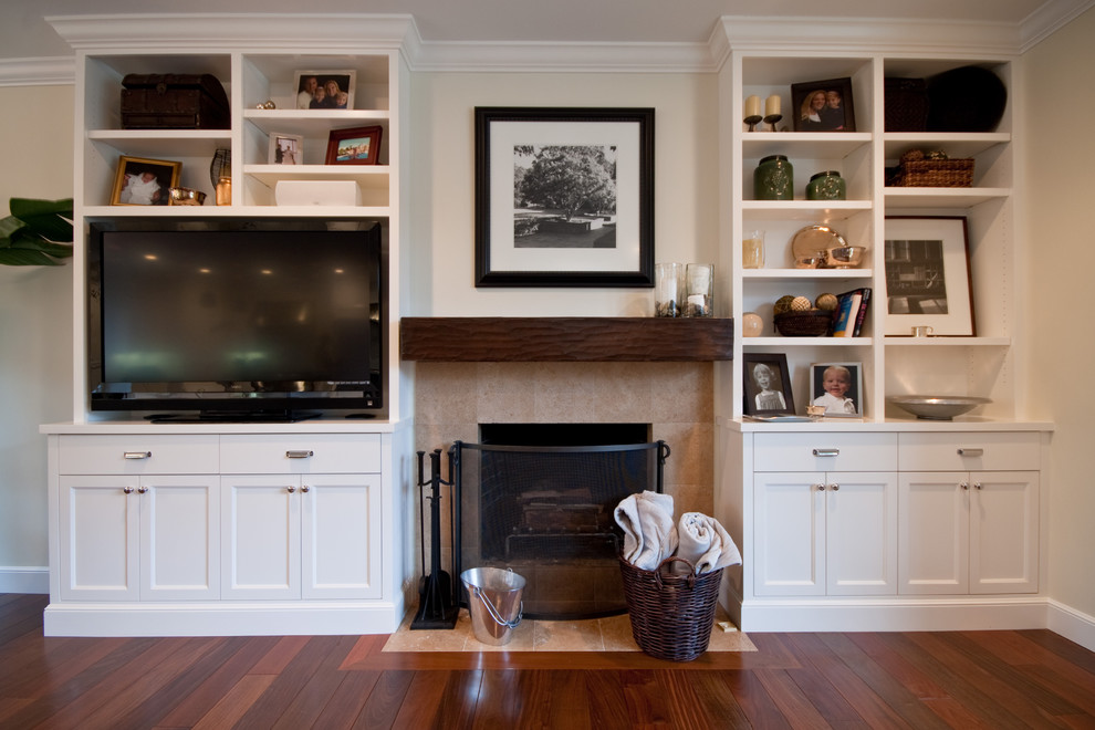 Inspiration for a traditional family room in San Francisco with beige walls, dark hardwood floors, a standard fireplace and a built-in media wall.