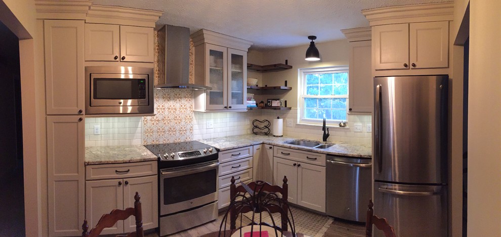 Kitchen - rustic brown floor kitchen idea in Cincinnati with a double-bowl sink, raised-panel cabinets, beige cabinets, granite countertops, white backsplash, terra-cotta backsplash and stainless steel appliances