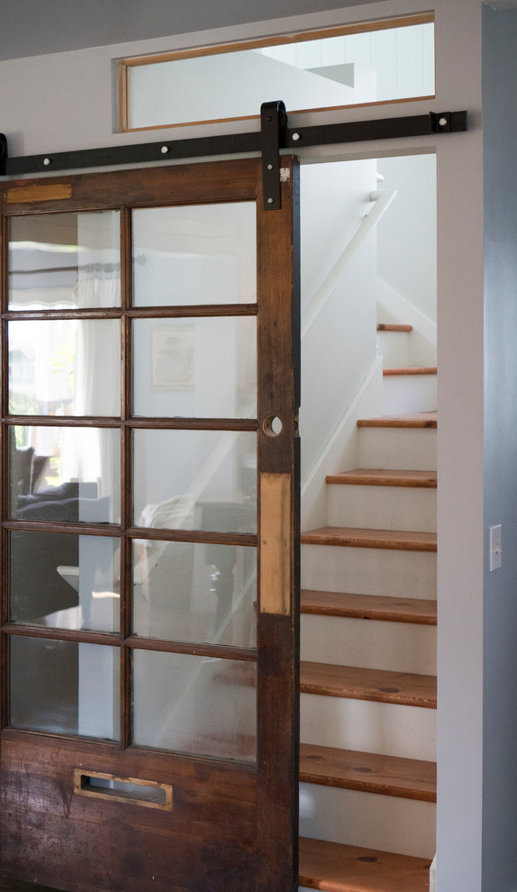Photo of a mid-sized arts and crafts wood l-shaped staircase in Seattle with painted wood risers.
