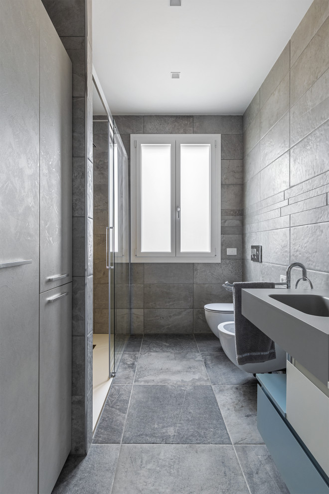 Inspiration for a large contemporary cloakroom in Other with flat-panel cabinets, turquoise cabinets, a wall mounted toilet, grey tiles, porcelain tiles, white walls, porcelain flooring, an integrated sink, laminate worktops, brown floors, beige worktops, a floating vanity unit, a drop ceiling and panelled walls.