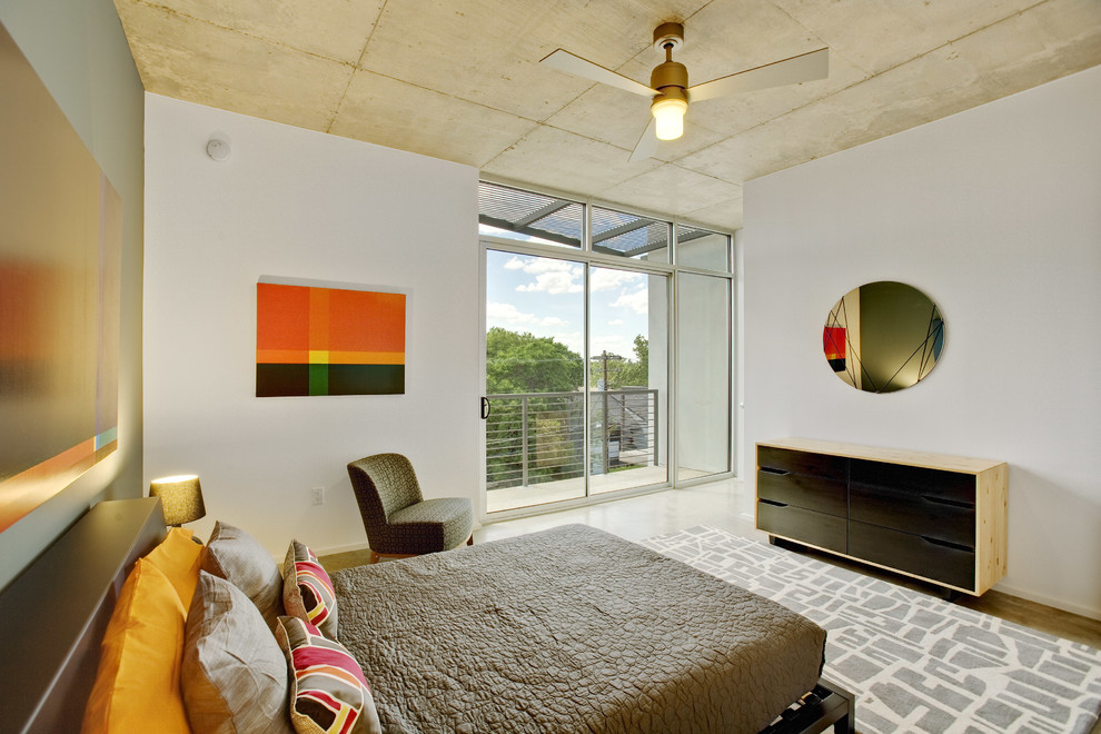 Photo of a contemporary bedroom in Austin with white walls.