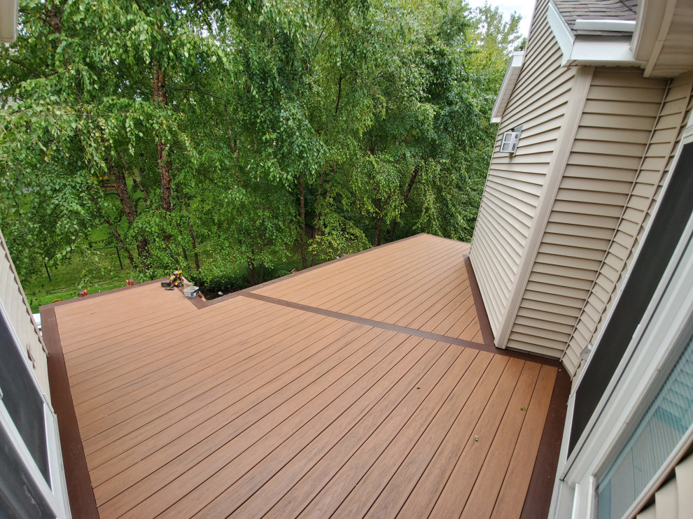 Deck - mid-sized backyard second story metal railing deck idea with no cover