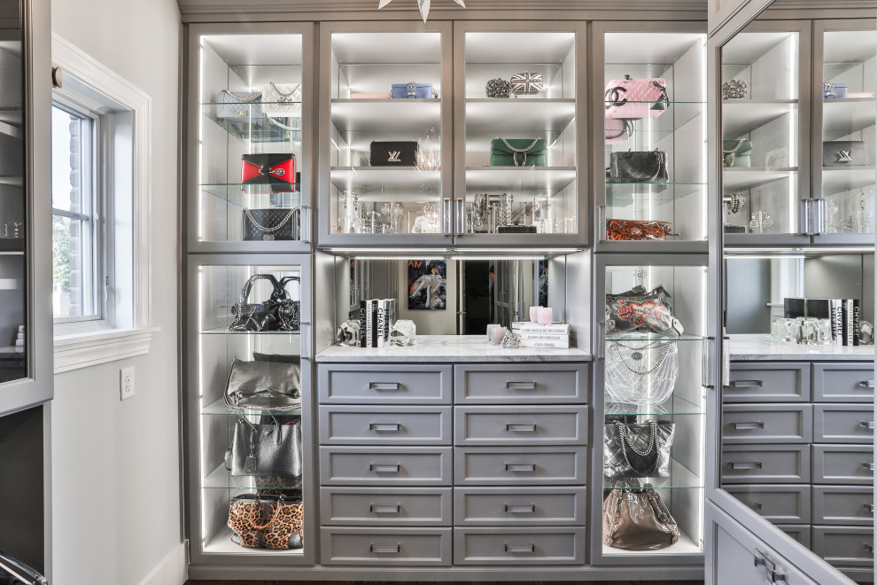 Design ideas for a large contemporary gender-neutral walk-in wardrobe in St Louis with shaker cabinets, grey cabinets, laminate floors and brown floor.