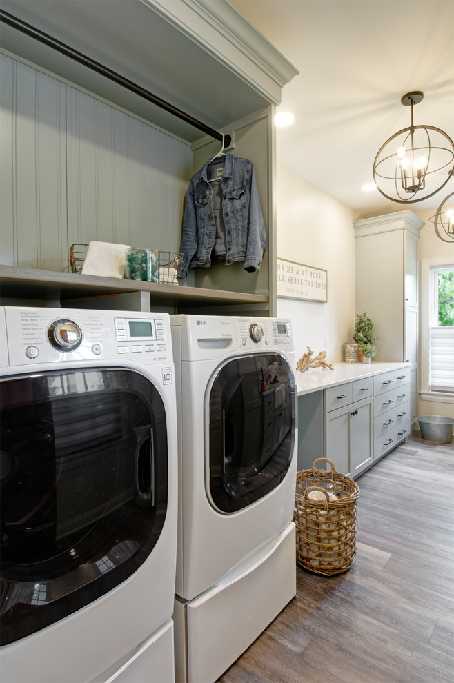 Photo of a mid-sized country galley utility room in Columbus with a farmhouse sink, shaker cabinets, grey cabinets, quartzite benchtops, beige walls, vinyl floors, a side-by-side washer and dryer, multi-coloured floor and white benchtop.