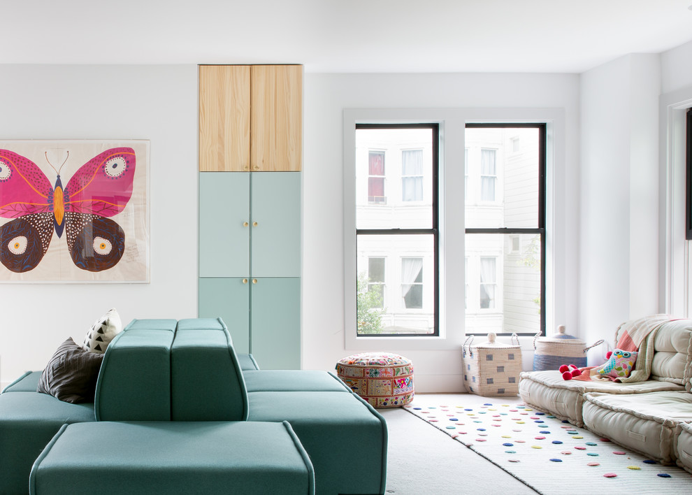 Photo of a large contemporary gender-neutral kids' playroom for kids 4-10 years old in San Francisco with white walls and light hardwood floors.