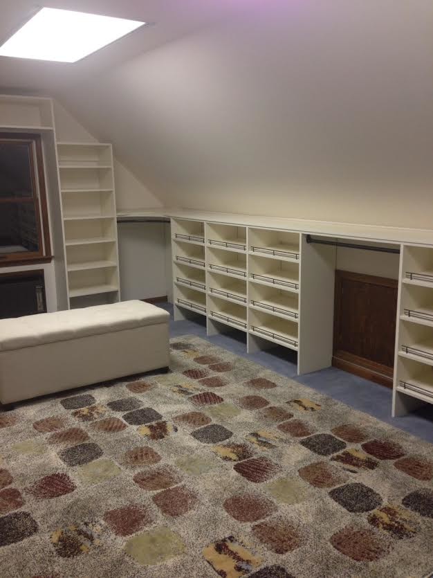 Photo of a large modern gender-neutral walk-in wardrobe in Huntington with open cabinets, white cabinets, carpet and multi-coloured floor.