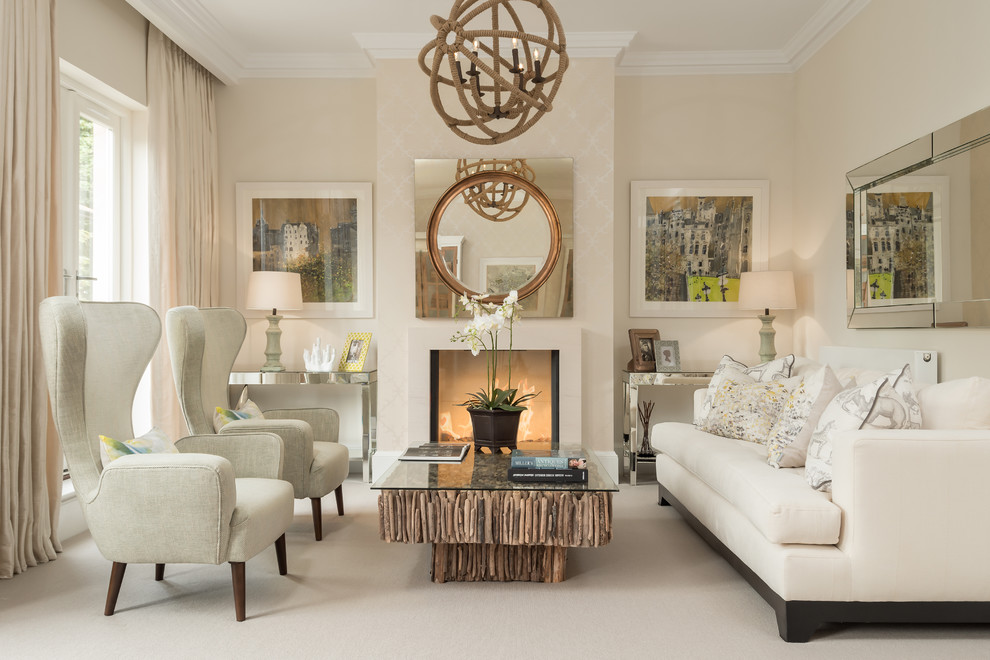 This is an example of a mid-sized transitional formal living room in London with beige walls, carpet and a standard fireplace.