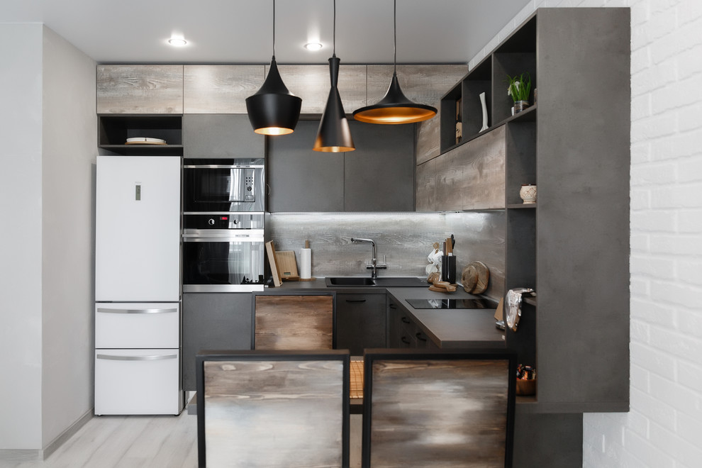 This is an example of a small industrial u-shaped separate kitchen in Moscow with flat-panel cabinets, wood benchtops, brown splashback, timber splashback, stainless steel appliances, with island, grey floor, brown benchtop, a double-bowl sink, light wood cabinets and laminate floors.