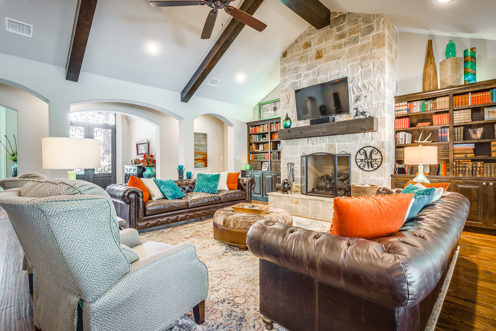 Photo of a mid-sized transitional open concept living room in Dallas with grey walls, dark hardwood floors, a hanging fireplace, a stone fireplace surround and a wall-mounted tv.