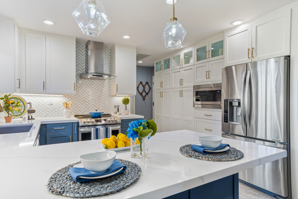 Kitchen pantry - mid-sized eclectic u-shaped vinyl floor and blue floor kitchen pantry idea in San Francisco with a single-bowl sink, shaker cabinets, white cabinets, quartz countertops, blue backsplash, glass tile backsplash, stainless steel appliances, a peninsula and white countertops