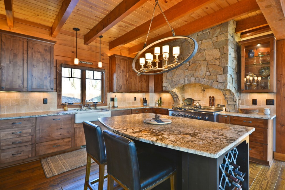 Eat-in kitchen - mid-sized rustic u-shaped medium tone wood floor and brown floor eat-in kitchen idea with a farmhouse sink, medium tone wood cabinets, granite countertops, beige backsplash, stone tile backsplash, stainless steel appliances, an island, shaker cabinets and brown countertops