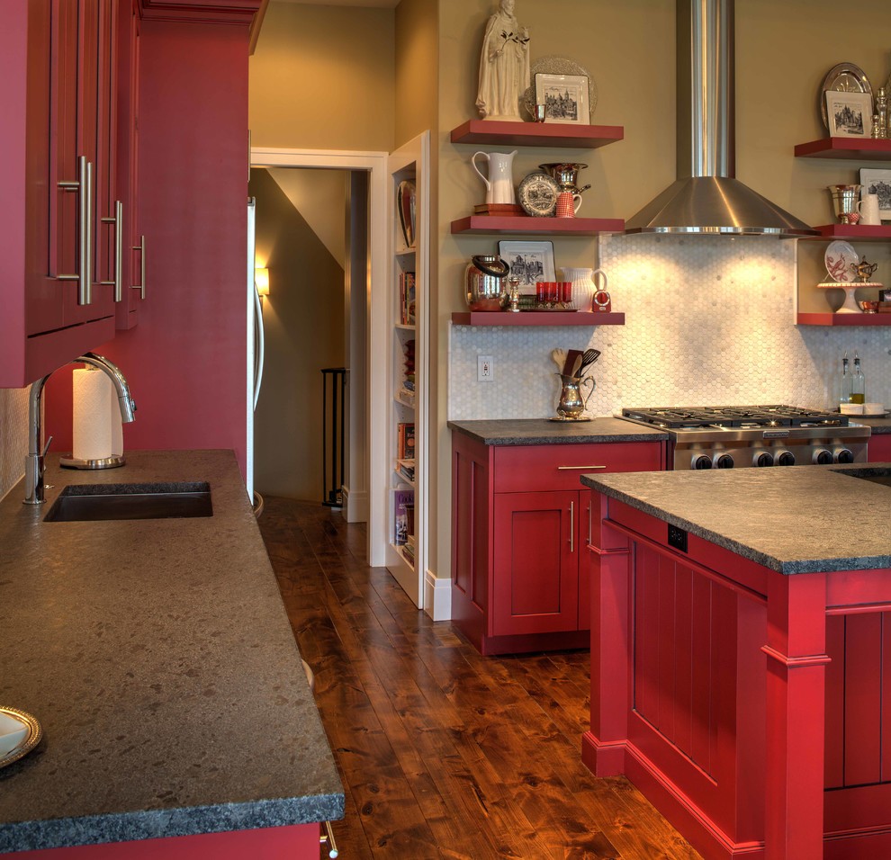 This is an example of a mid-sized traditional u-shaped kitchen pantry in Kansas City with an undermount sink, recessed-panel cabinets, red cabinets, granite benchtops, white splashback, mosaic tile splashback, stainless steel appliances, medium hardwood floors and with island.