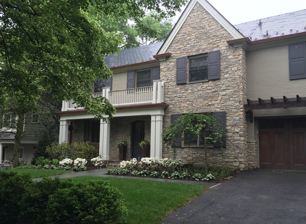 This is an example of a mid-sized transitional two-storey beige house exterior in DC Metro with mixed siding, a gable roof and a shingle roof.