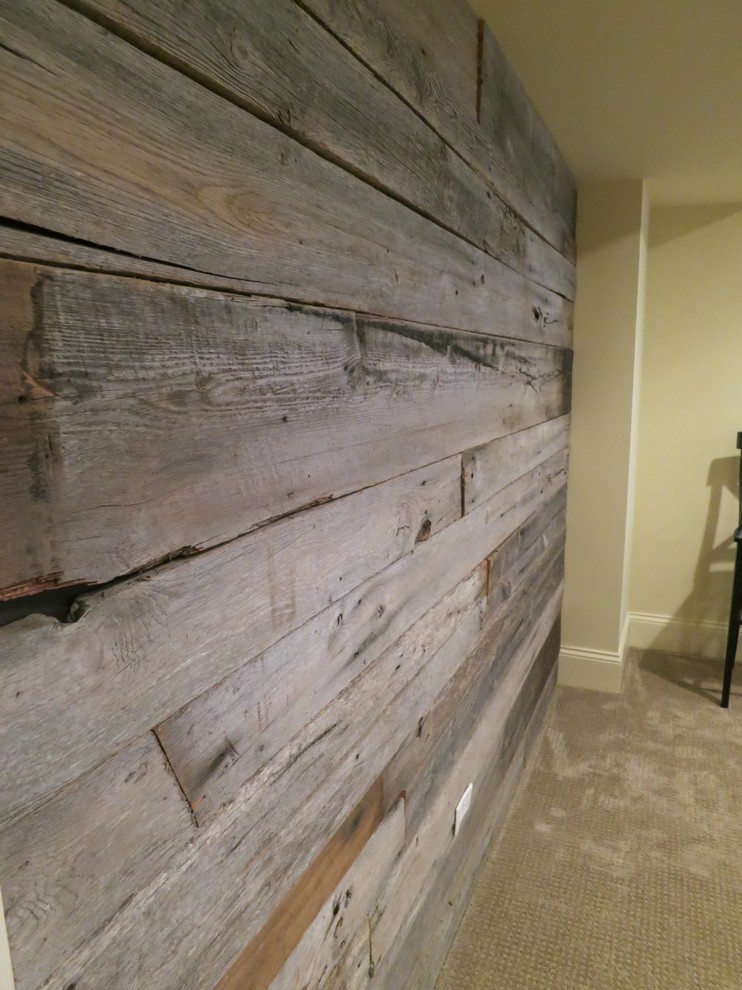 Example of a large mountain style look-out carpeted basement design in Chicago with no fireplace and beige walls