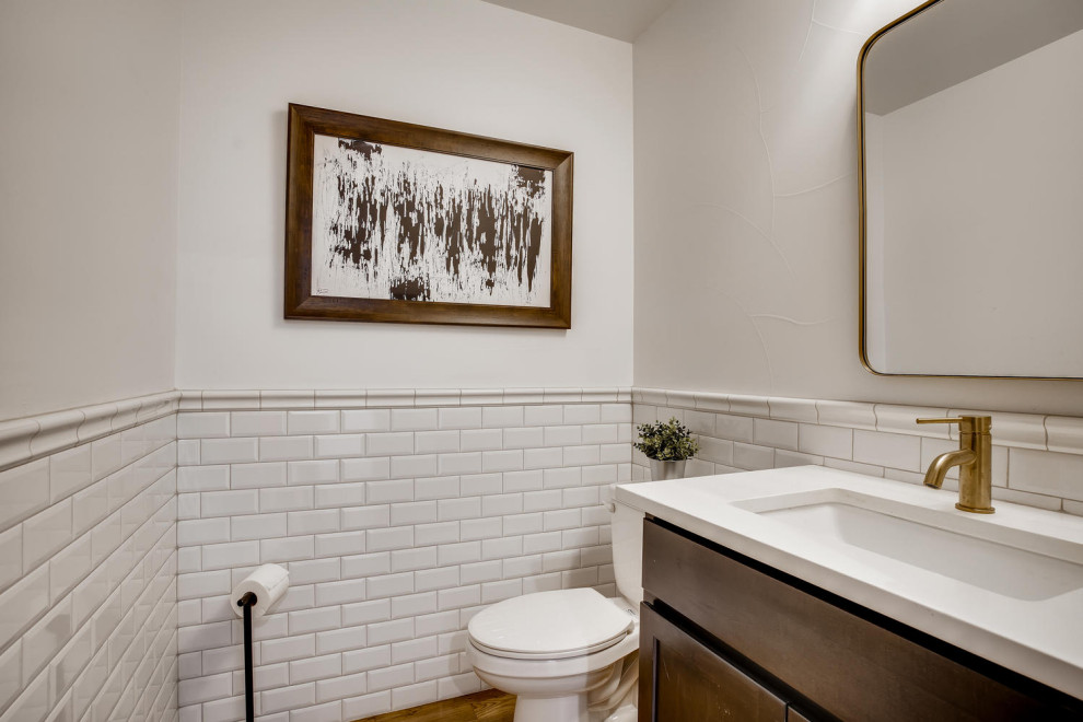 Small traditional cloakroom in Denver with shaker cabinets, dark wood cabinets, a one-piece toilet, white tiles, porcelain tiles, white walls, a submerged sink, quartz worktops, white worktops and a built in vanity unit.