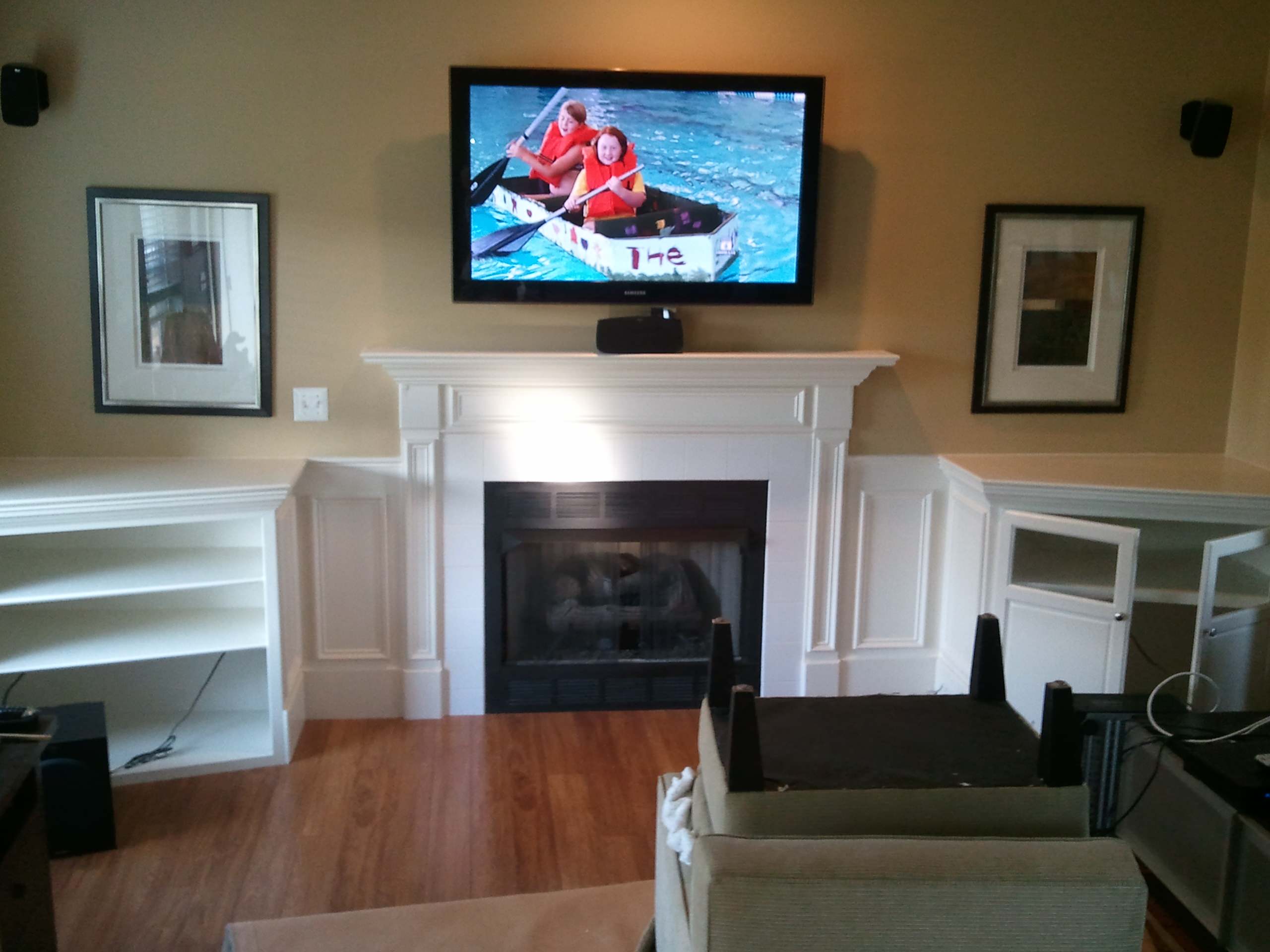 Built In Shelving and Cabinets To Hide Electronics and Surround Fireplace