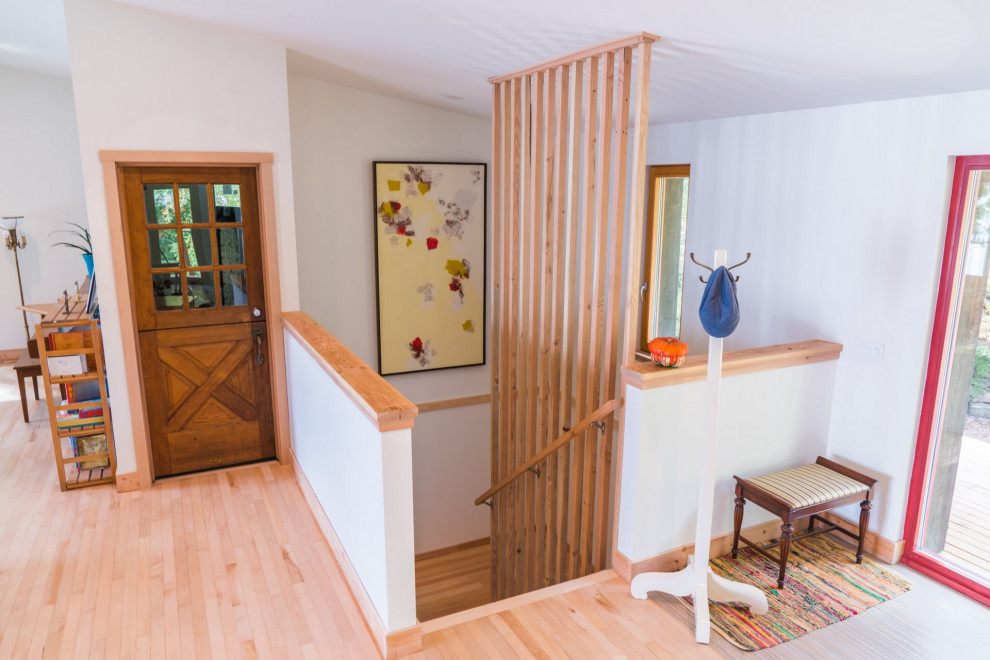 Mid-sized transitional wood u-shaped staircase in Other with wood risers and wood railing.