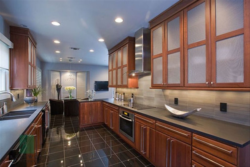 Enclosed kitchen - mid-sized transitional galley porcelain tile and black floor enclosed kitchen idea with a double-bowl sink, shaker cabinets, dark wood cabinets, granite countertops, beige backsplash, stainless steel appliances, no island, ceramic backsplash and gray countertops