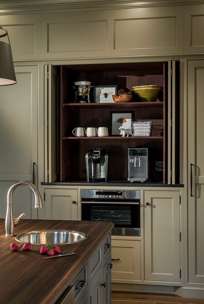 Design ideas for an expansive traditional u-shaped separate kitchen in Chicago with a farmhouse sink, beaded inset cabinets, grey cabinets, granite benchtops, multi-coloured splashback, porcelain splashback, panelled appliances, medium hardwood floors, with island and brown floor.
