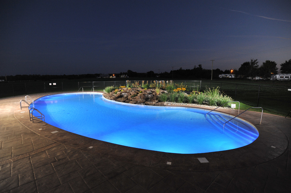 Inspiration for a huge rustic courtyard stamped concrete and freeform natural pool fountain remodel