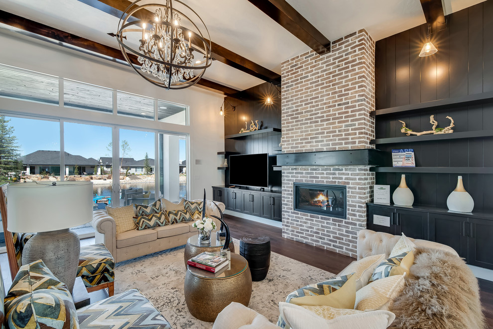 Expansive transitional open concept living room in Boise with white walls, medium hardwood floors, a ribbon fireplace, a brick fireplace surround, a freestanding tv and brown floor.