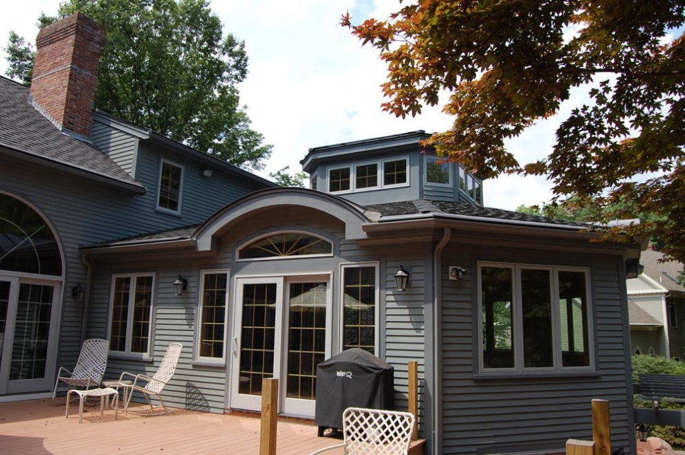 Example of a mid-sized transitional gray two-story vinyl house exterior design in Boston with a shingle roof and a gray roof