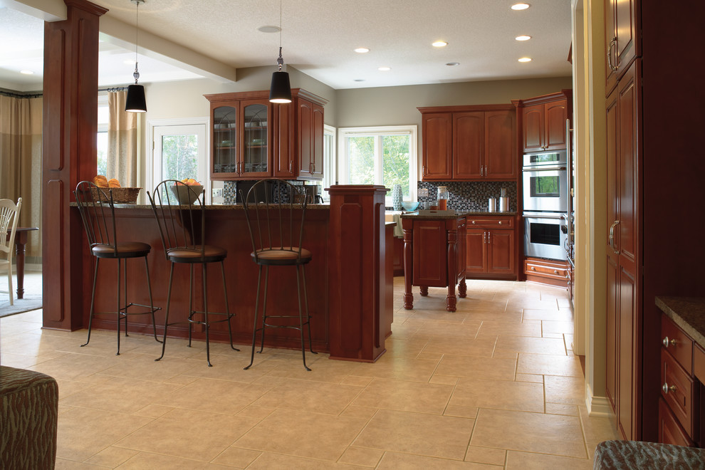 Eat-in kitchen - transitional porcelain tile eat-in kitchen idea in Miami with raised-panel cabinets, dark wood cabinets, multicolored backsplash, mosaic tile backsplash and stainless steel appliances