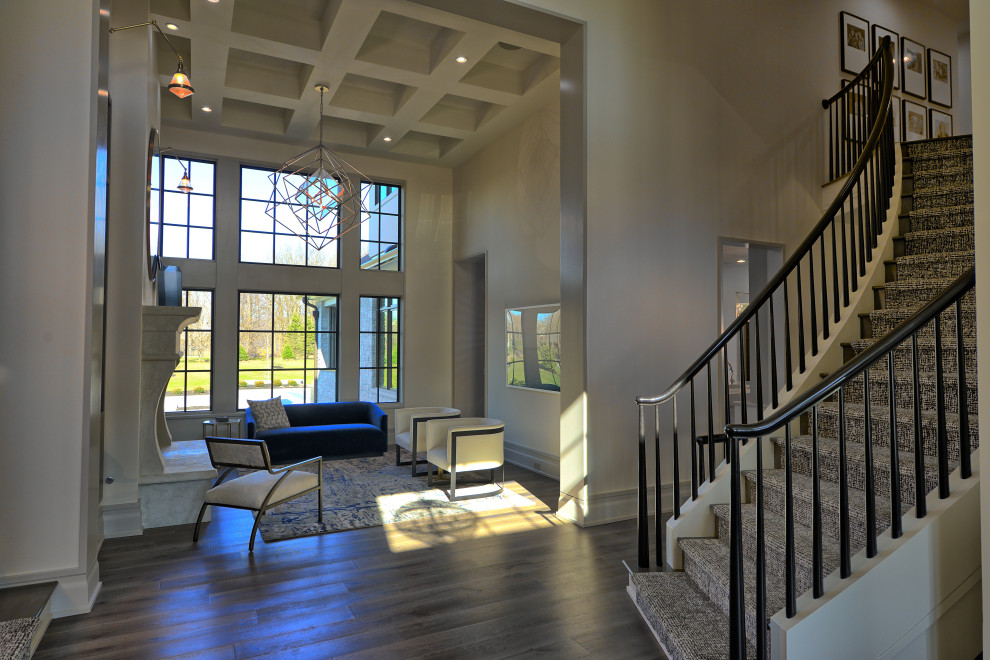 Design ideas for a large modern foyer in Indianapolis with beige walls, a double front door, a dark wood front door, brown floor, coffered and medium hardwood floors.
