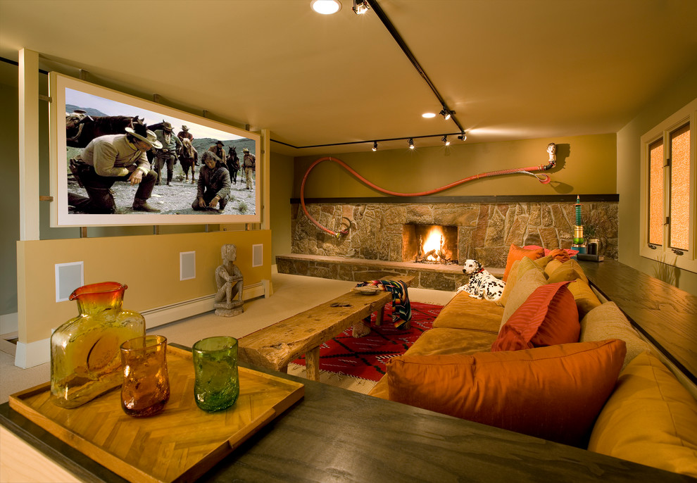 This is an example of an eclectic home theatre in Albuquerque with a projector screen.