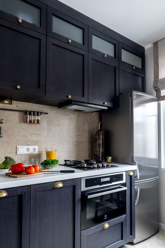 This is an example of a small transitional single-wall separate kitchen in Moscow with an integrated sink, recessed-panel cabinets, dark wood cabinets, beige splashback, stainless steel appliances, no island and beige floor.
