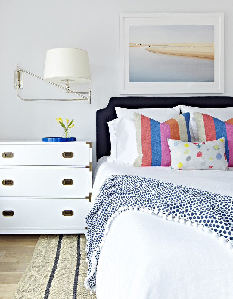 Mid-sized beach style guest light wood floor bedroom photo in New York with white walls and no fireplace