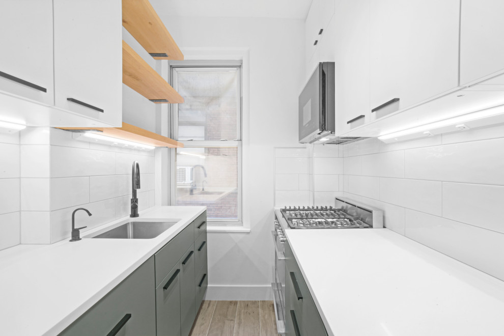 Design ideas for a small scandi kitchen in New York with engineered stone countertops, white splashback, metro tiled splashback, stainless steel appliances, beige floors and white worktops.