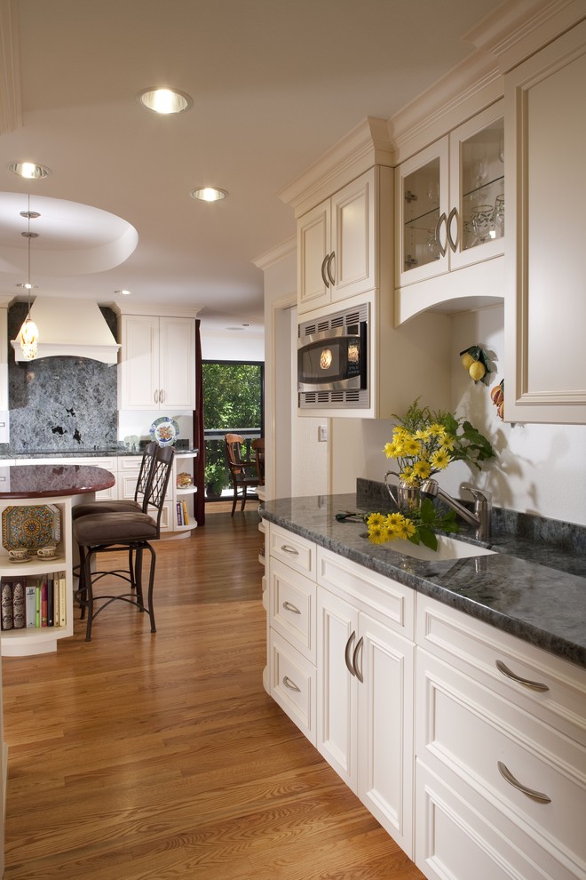 This is an example of a traditional kitchen in San Francisco with an undermount sink, recessed-panel cabinets and white cabinets.