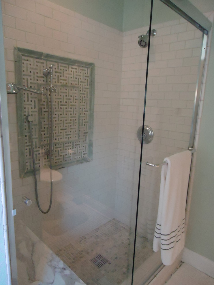 Design ideas for a mid-sized traditional master bathroom in Los Angeles with raised-panel cabinets, dark wood cabinets, a corner shower, a one-piece toilet, white tile, marble, green walls, marble floors, an undermount sink, marble benchtops, green floor, a sliding shower screen and white benchtops.