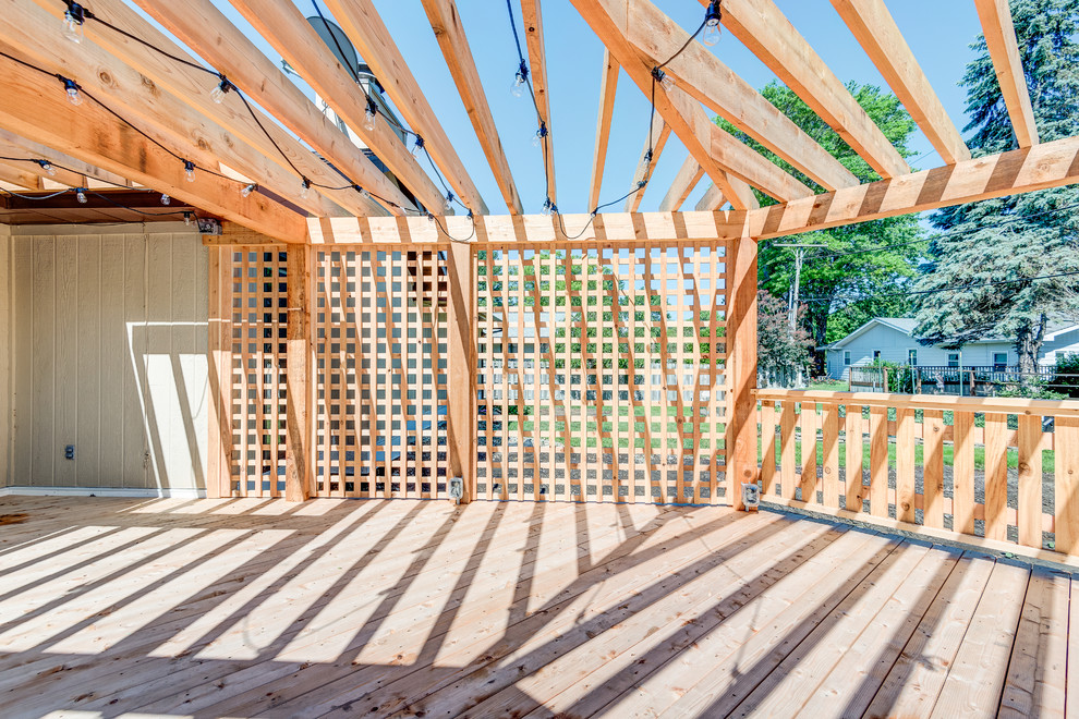 Inspiration for a large transitional backyard deck remodel in Chicago with a pergola