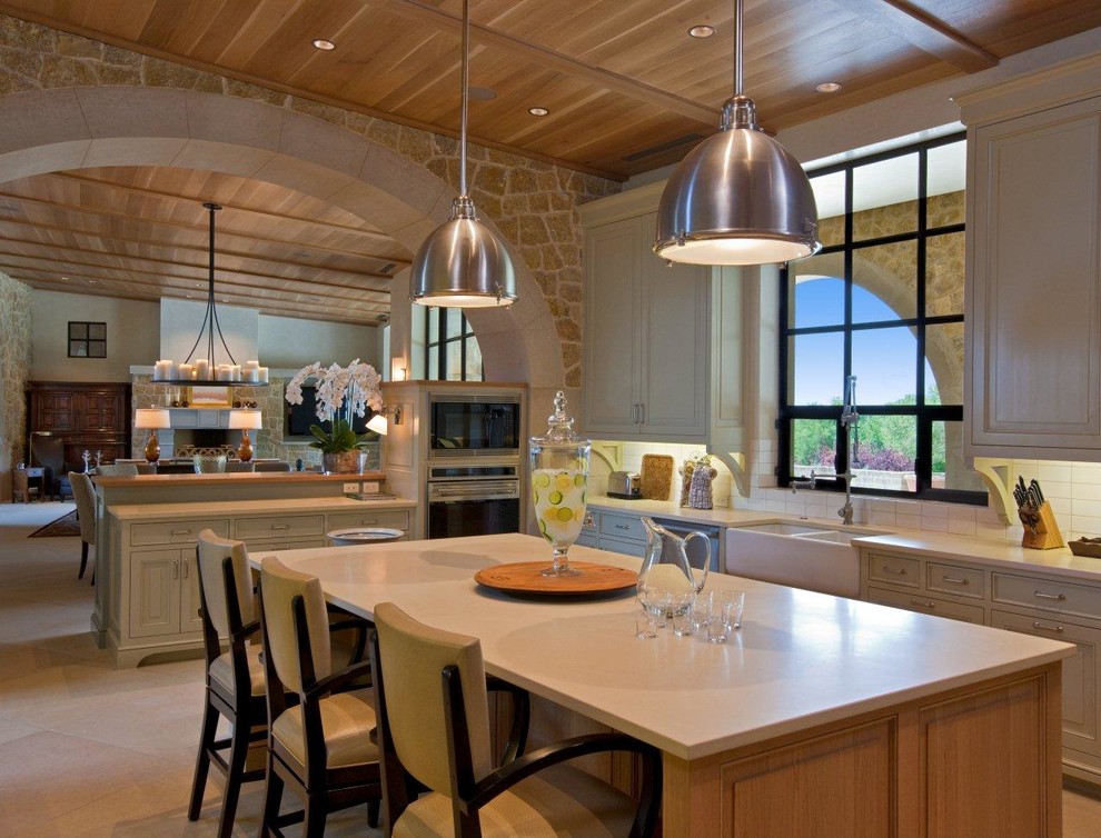 Open concept kitchen - large rustic u-shaped open concept kitchen idea in Austin with an undermount sink, flat-panel cabinets, light wood cabinets, beige backsplash, stainless steel appliances and an island