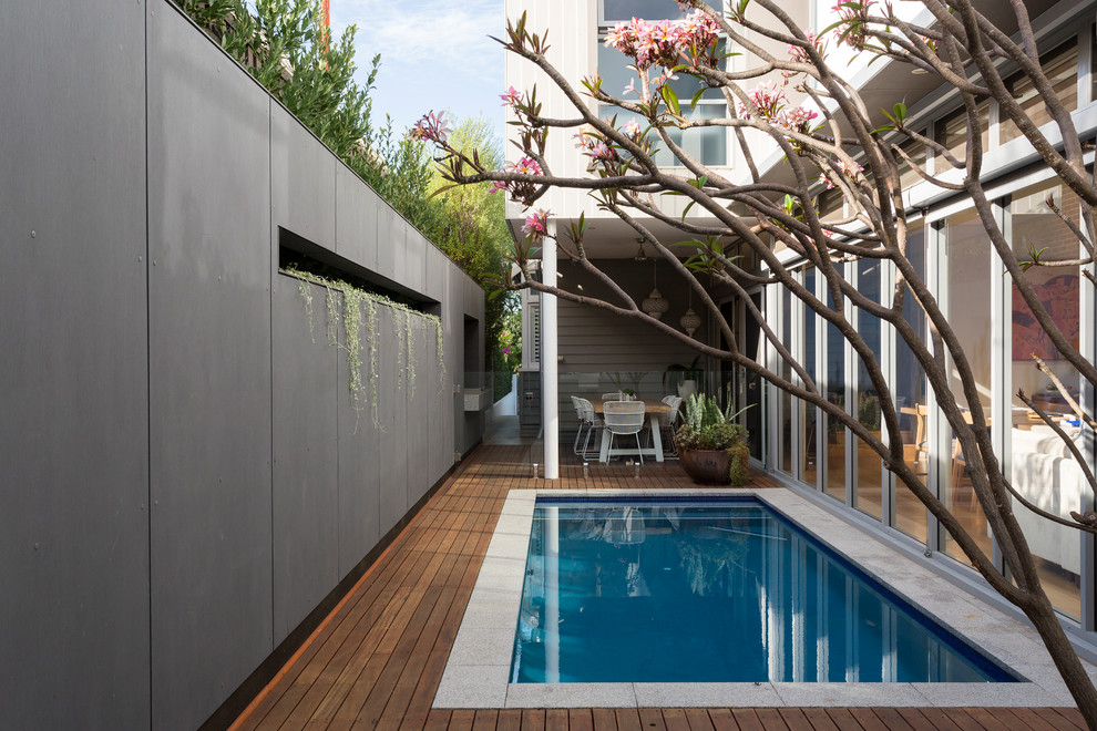 Photo of a small backyard rectangular pool in Perth with decking.