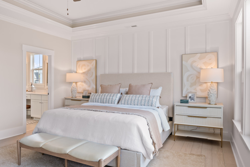 Inspiration for a transitional light wood floor, beige floor, tray ceiling and wall paneling bedroom remodel in Other with white walls