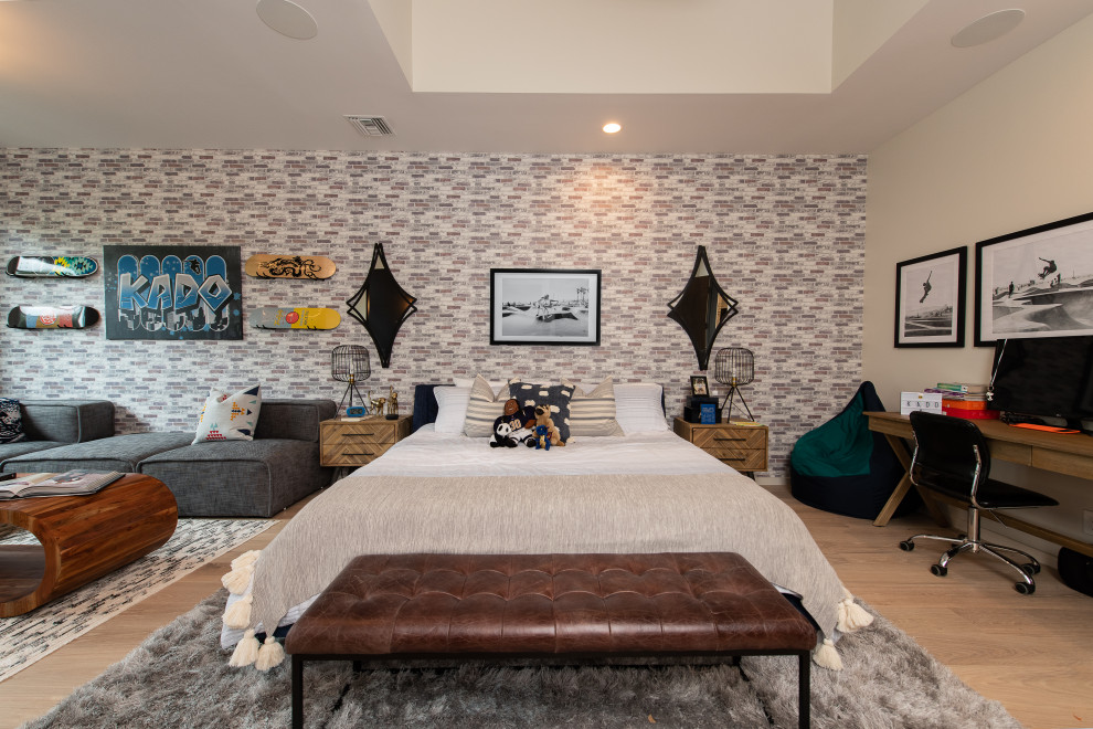 Contemporary bedroom in Orange County with beige walls, medium hardwood floors, brown floor and wallpaper.
