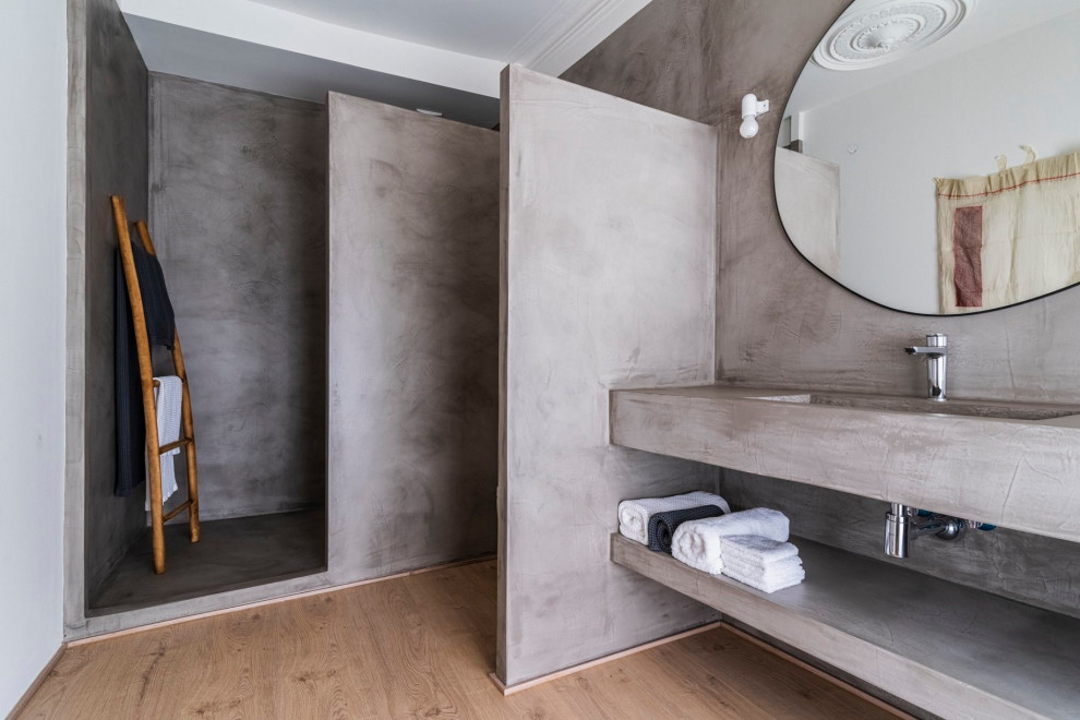 Example of a zen master light wood floor, brown floor, single-sink and coffered ceiling bathroom design in Barcelona with open cabinets, gray cabinets, an integrated sink, concrete countertops, gray countertops and a built-in vanity
