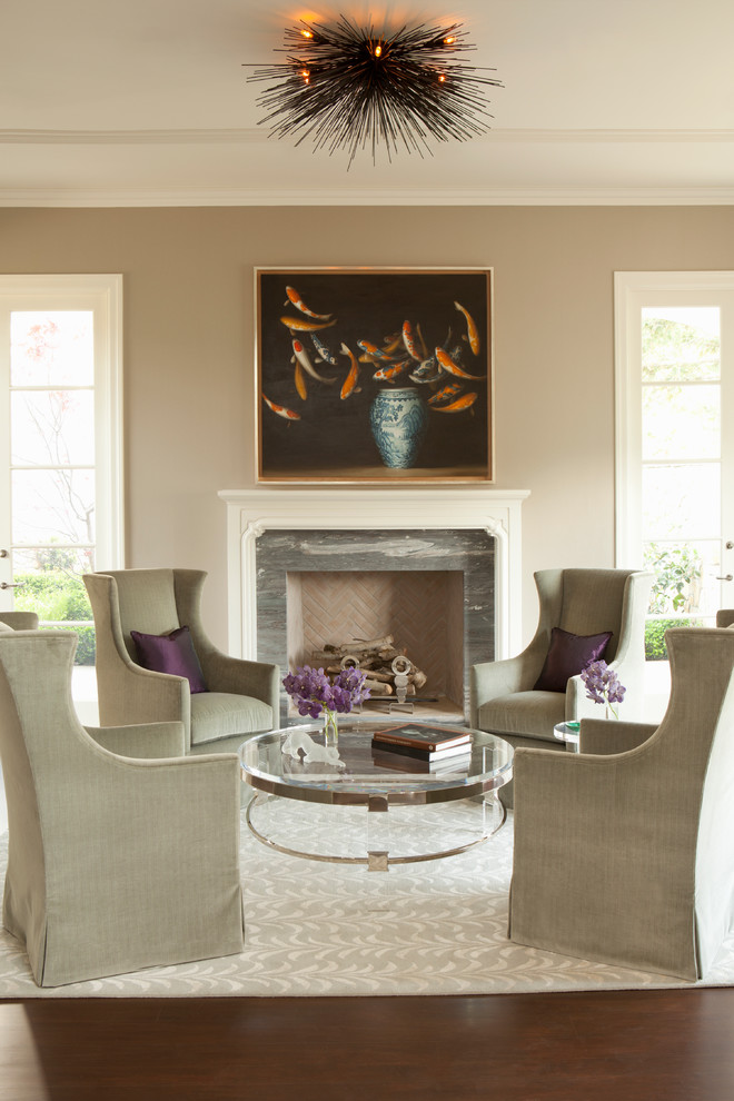 Photo of a traditional living room in Los Angeles with beige walls and a standard fireplace.