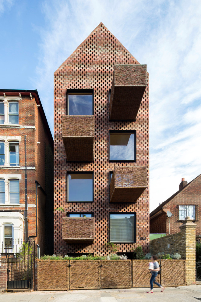 Inspiration for a mid-sized contemporary three-storey house exterior in London.