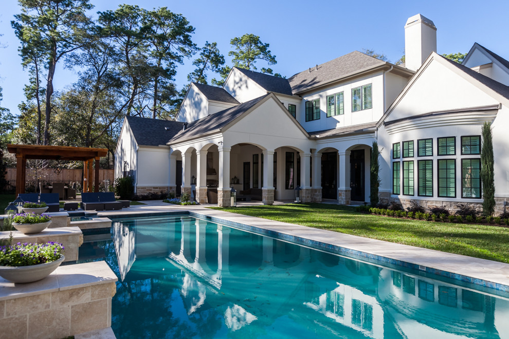 Mid-sized transitional backyard tile and rectangular hot tub photo in Houston