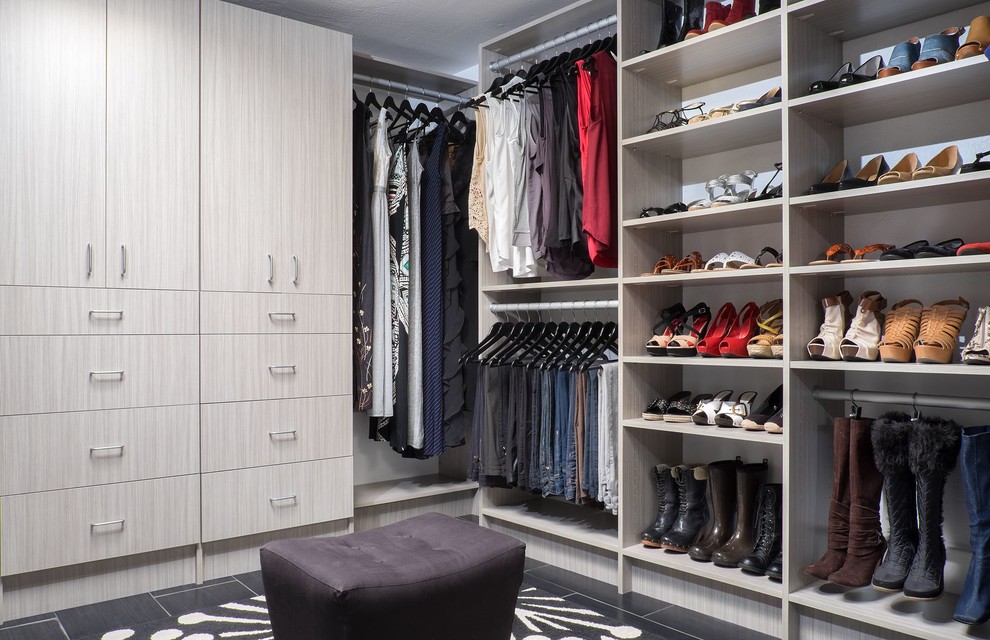 Large modern gender-neutral dressing room in Other with flat-panel cabinets, light wood cabinets, porcelain floors and black floor.