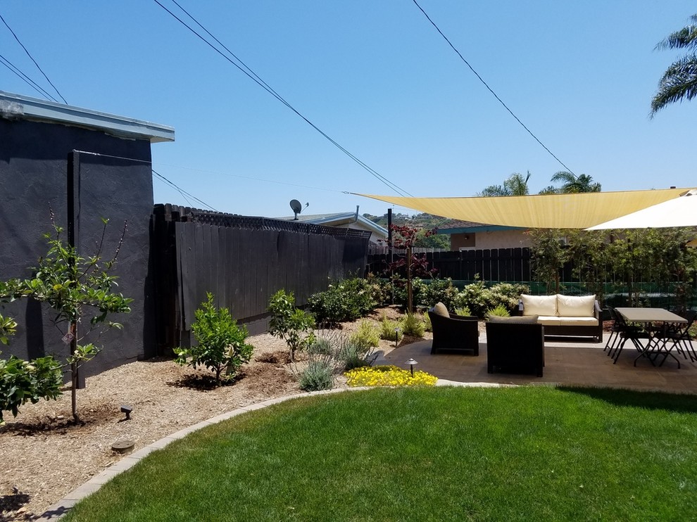 This is an example of a mid-sized traditional backyard patio in San Diego.