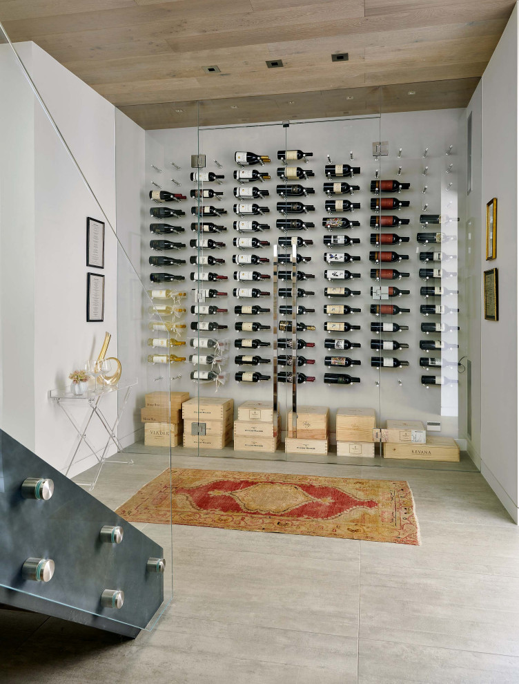 Contemporary wine cellar in Denver with display racks and grey floor.